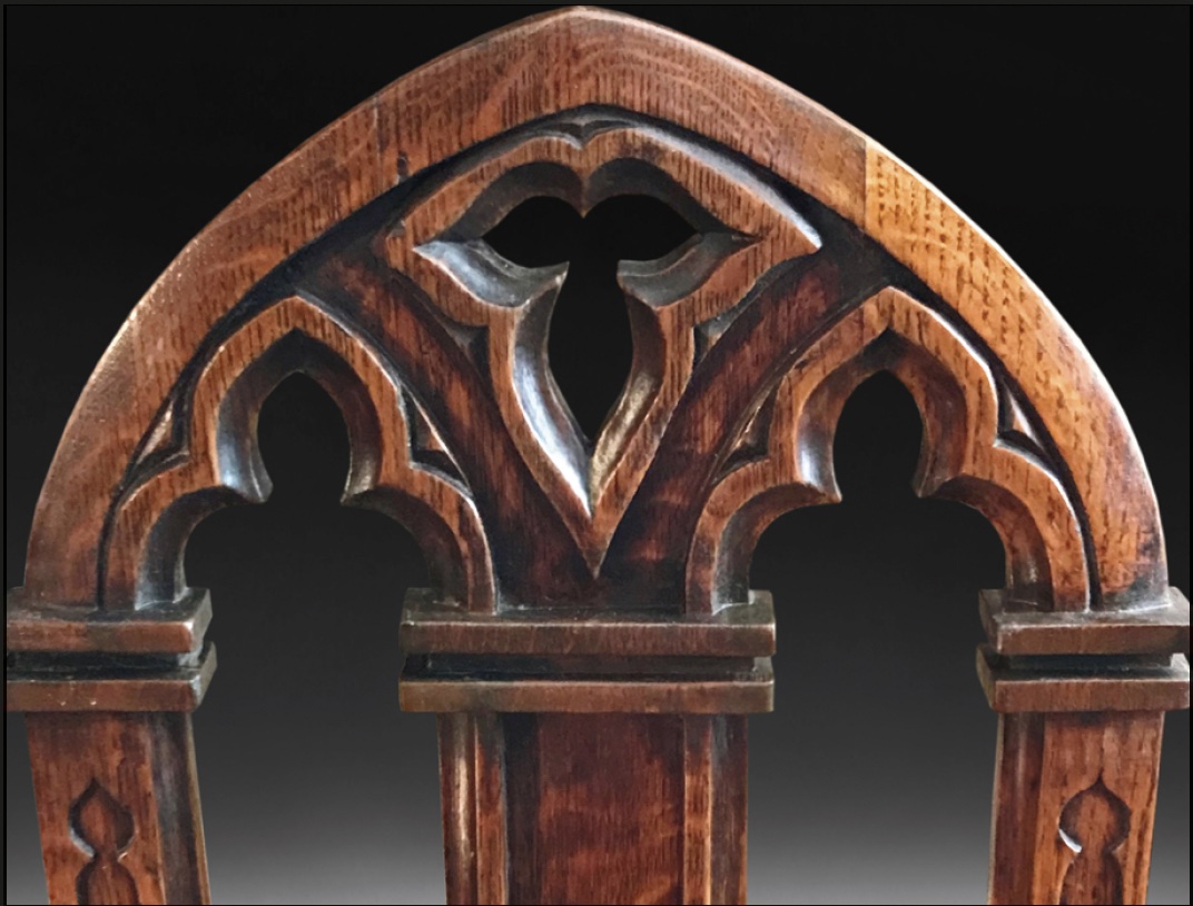 Trefoil details on the arched back of a gothic chair