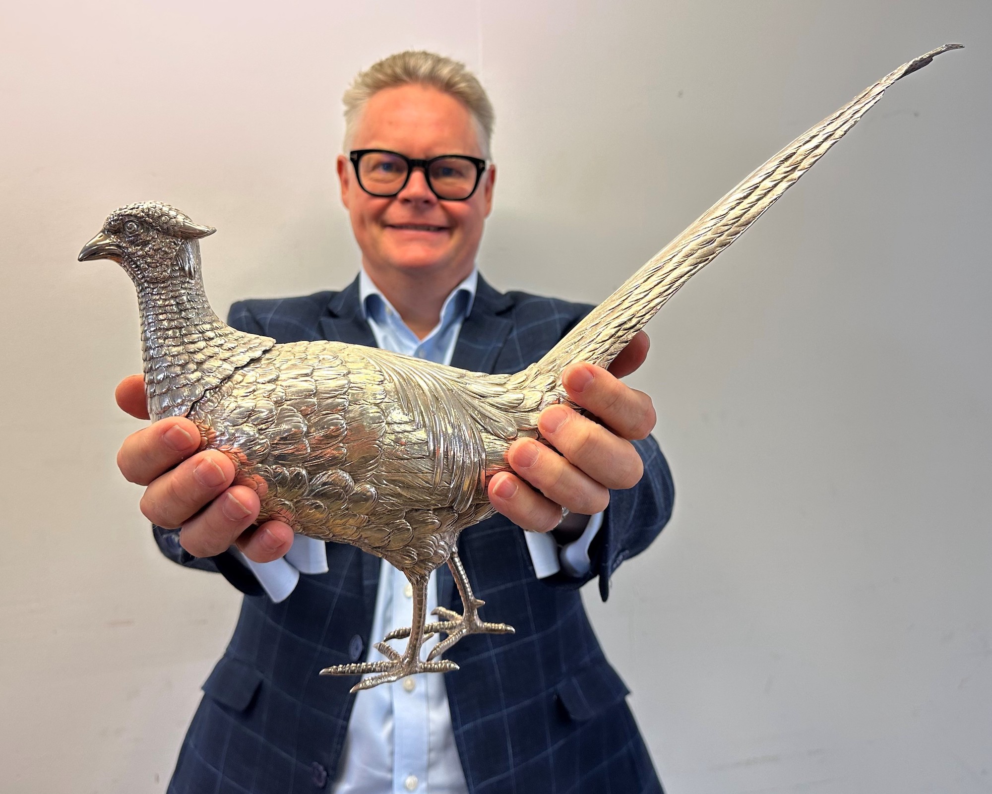 Auctioneer with silver pheasant-shaped wine decanter