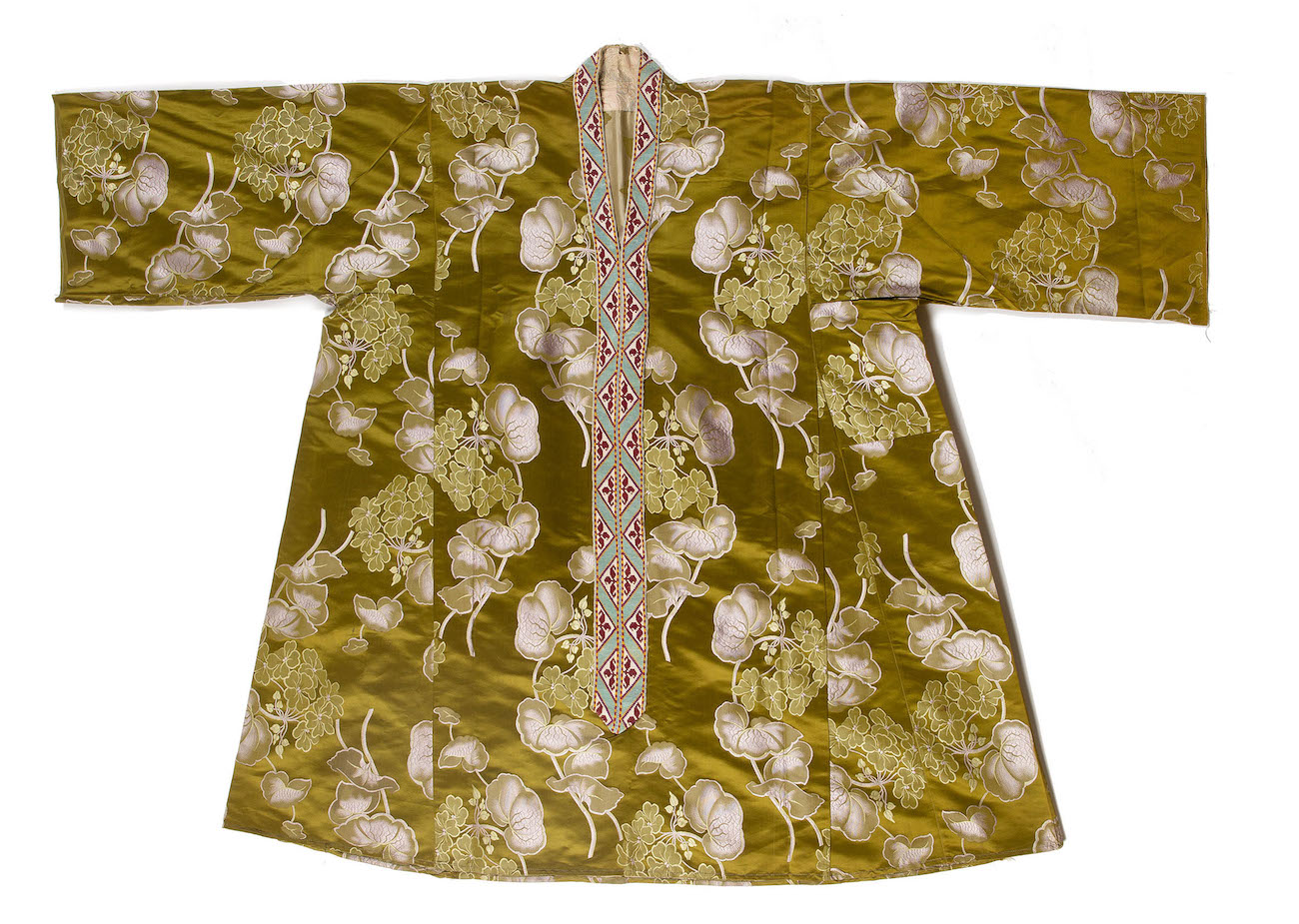 A Turkish, woven silk dress with green ground, woven flowers and handmade panels