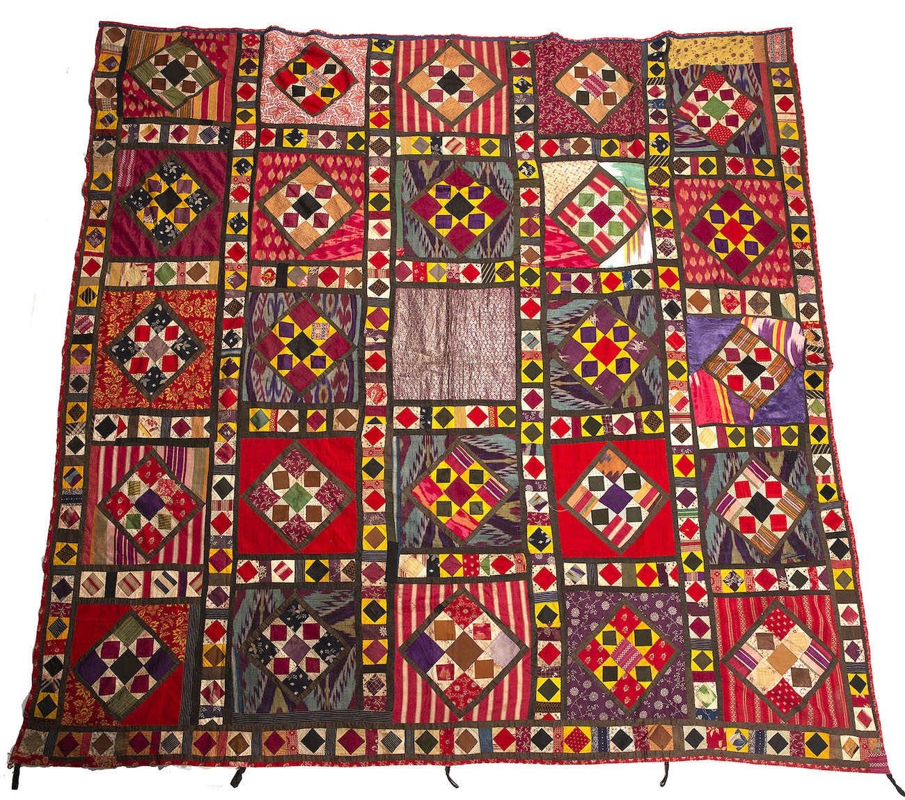 A sampler bed cover from Uzbekistan, made from scraps of old silk chapans, mostly pre-1900