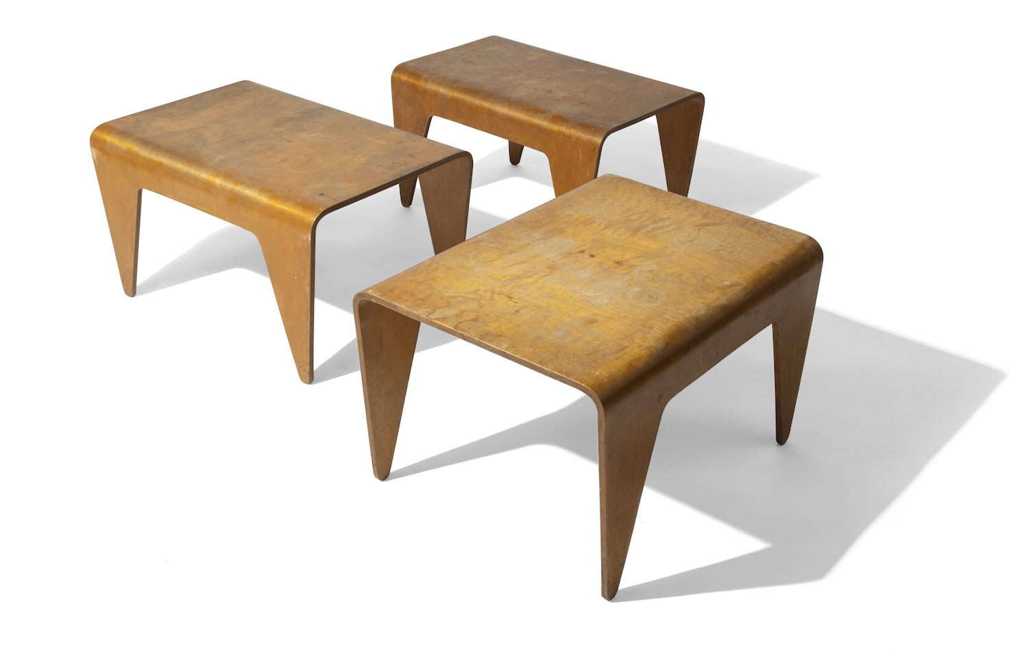 A nest of three birch plywood tables by Marcel Breuer