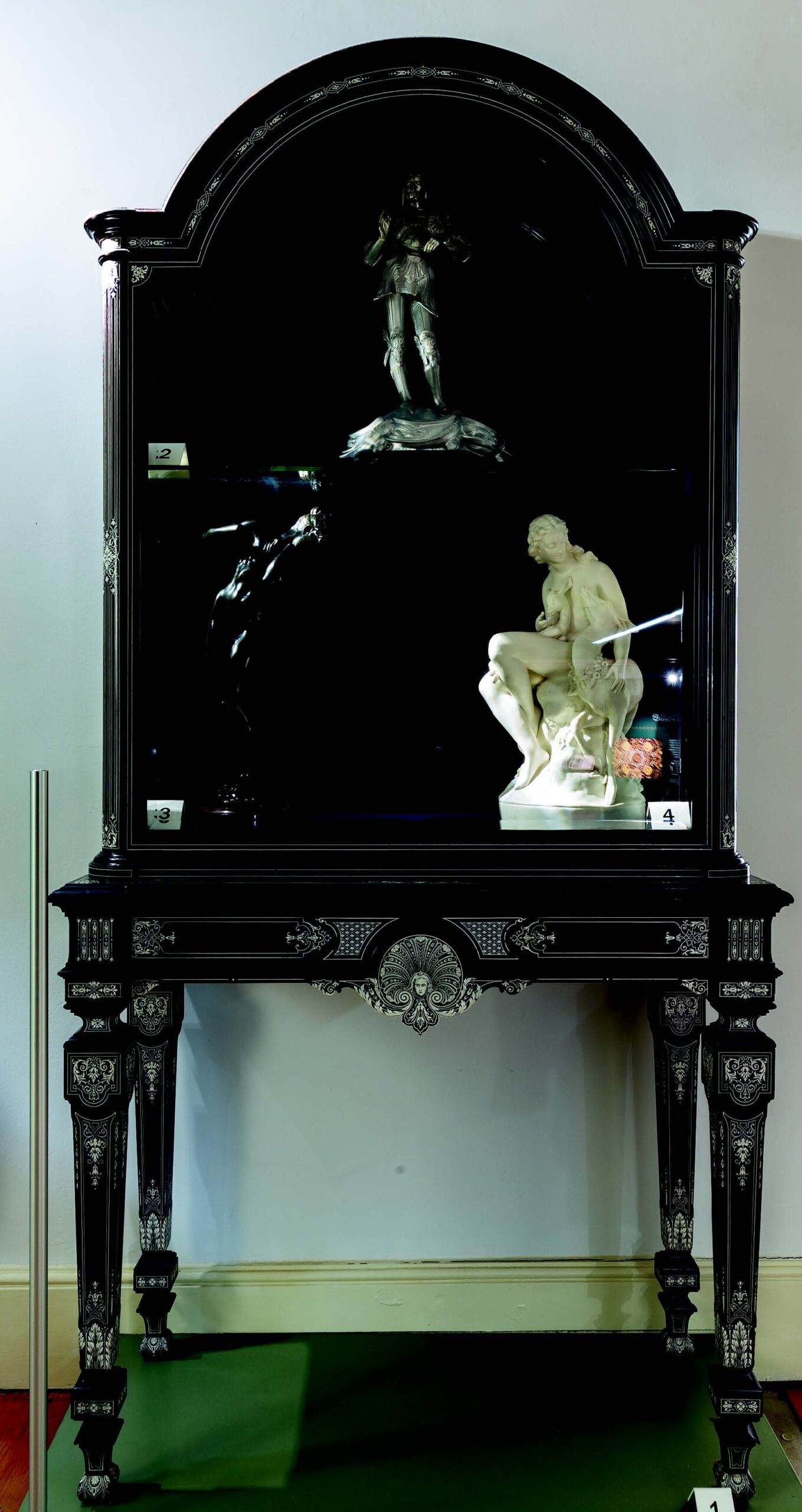 An ebonised display cabinet with ivory inlay, possibly designed by Owen Jones and the only piece of Jackson & Graham furniture on record with the signature of Peter and Forster Graham, partners in the firm
