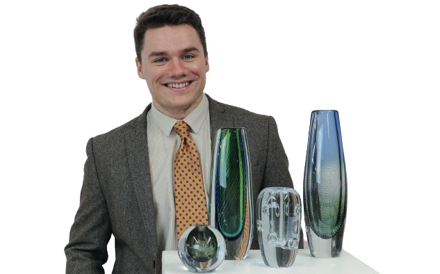 A man with a collection of vintage Swedish glass