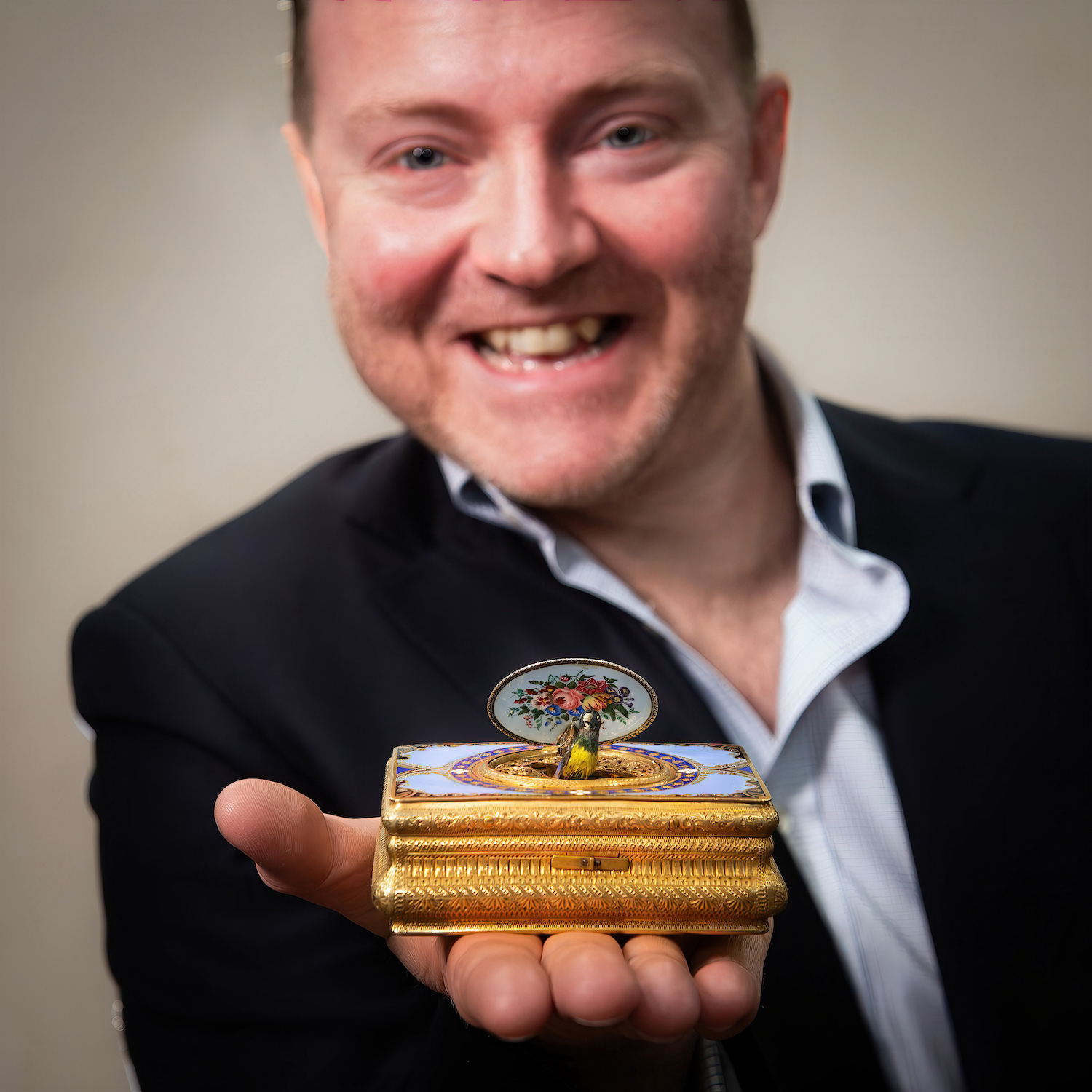 Auctioneer with antique singing bird box