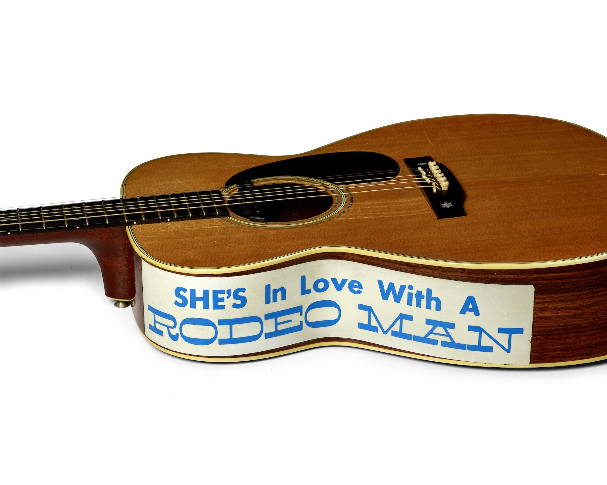 'She's in love with a rodeo man' sticker on the side of Eric Clapton's acoustic guitar