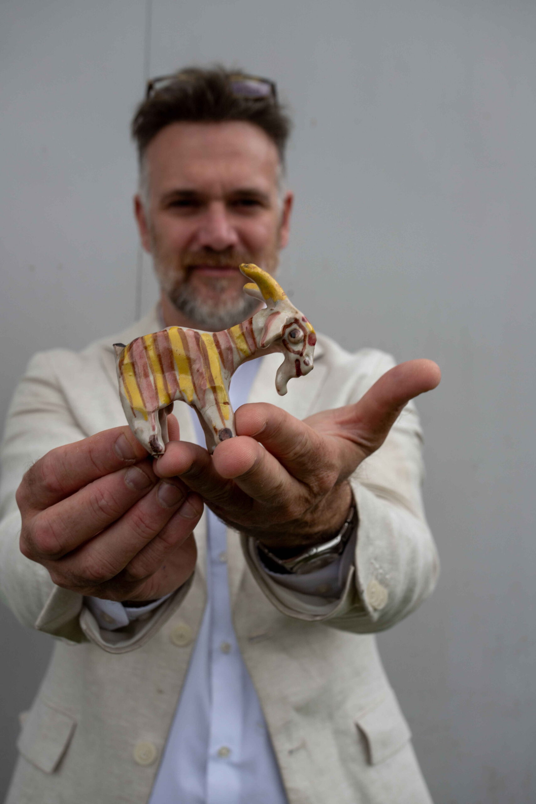 Charles Hanson, owner of Hansons Auctioneers, with the pottery goat made by King Charles