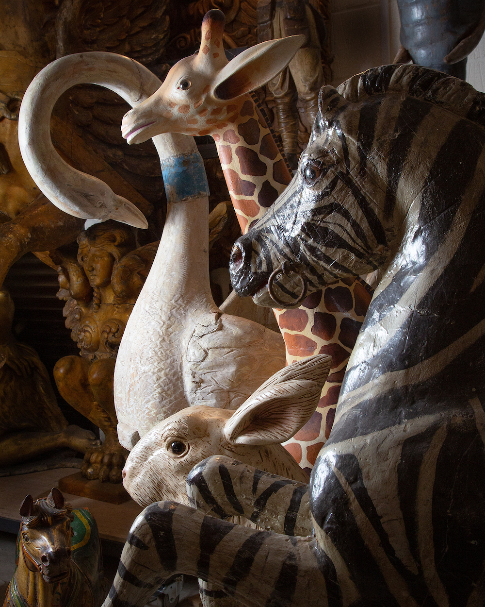 Carved wooden animals from a vintage fairground