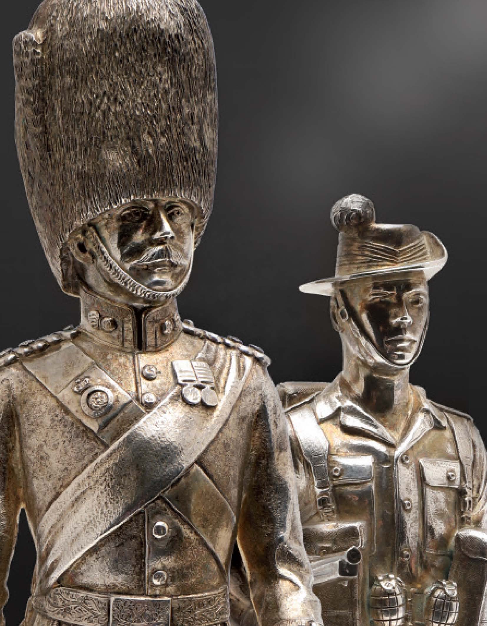 A pair of silver statuettes of military figures