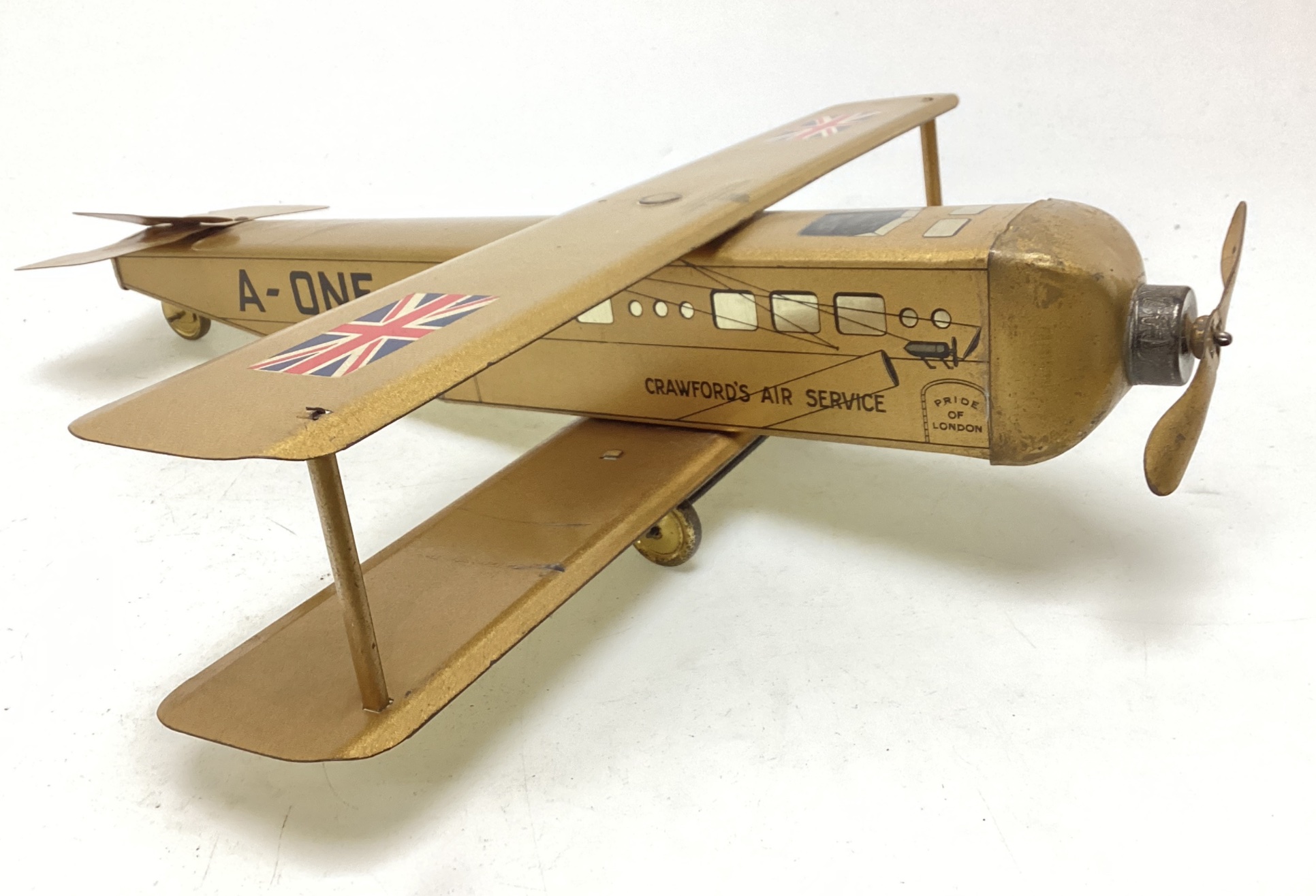 An antique biscuit tin in the shape of an aeroplane