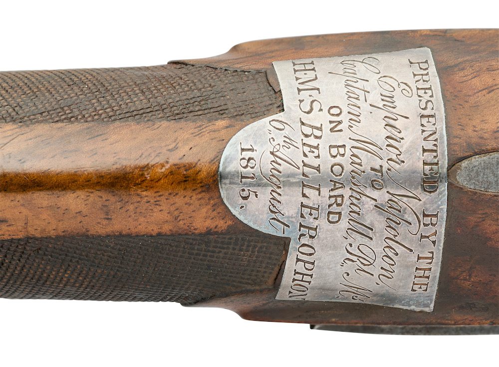 A small silver shield on a pair of pistols that belonged to Emperor Napoleon