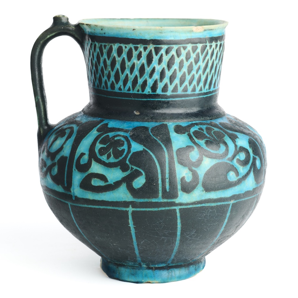 A Kashan turquoise-glazed silhouette ware jug