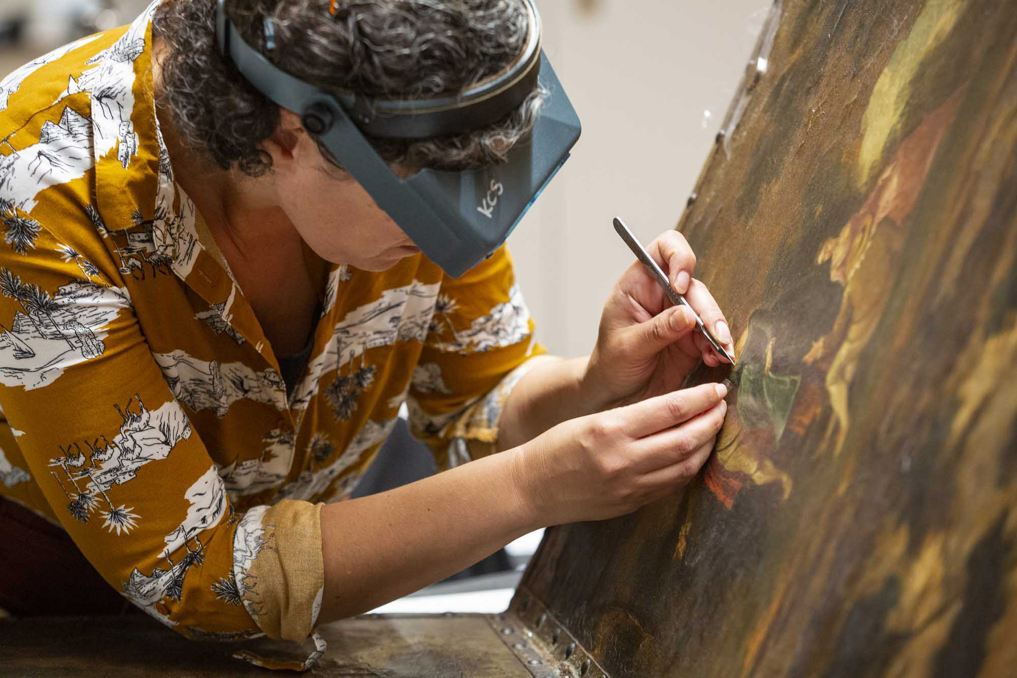 Taking a paint sample from some painted leather at the National Trust's Royal Oak Foundation Conservation Studio in Kent