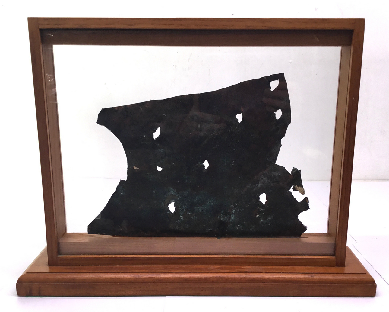 A fragment from HMS Bounty in a glass and wood presentation case