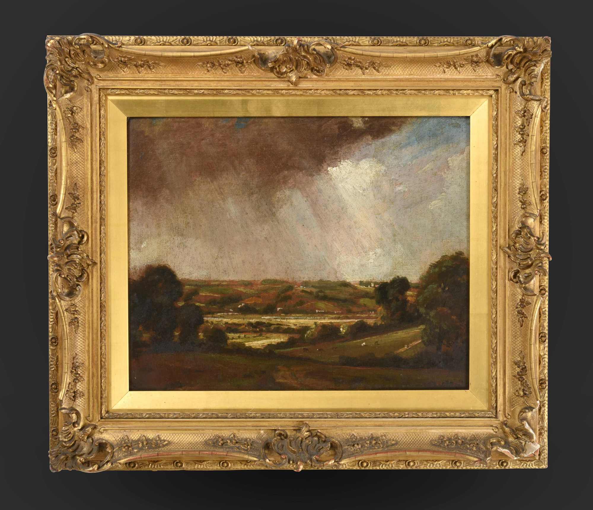 A framed painted sketch of countryside by John Constable