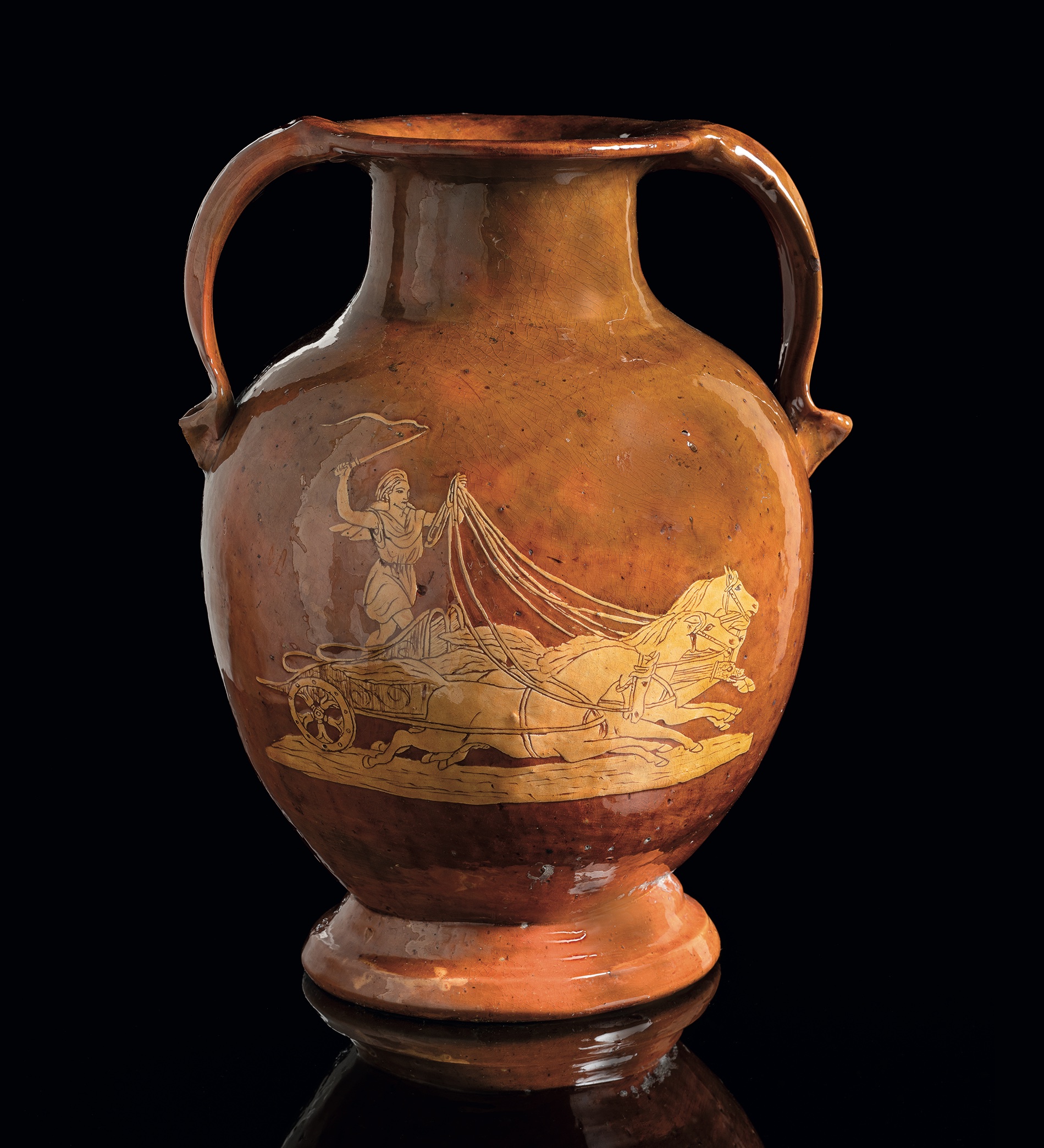 A Fremington Pottery twin-handled vase by Edwin Beer Fishley (1832-1912) decorated in slipware and sgraffito, with depictions of classical figures, including Pegasus, within a vine leaf border and flanked by stylised fish scroll handles