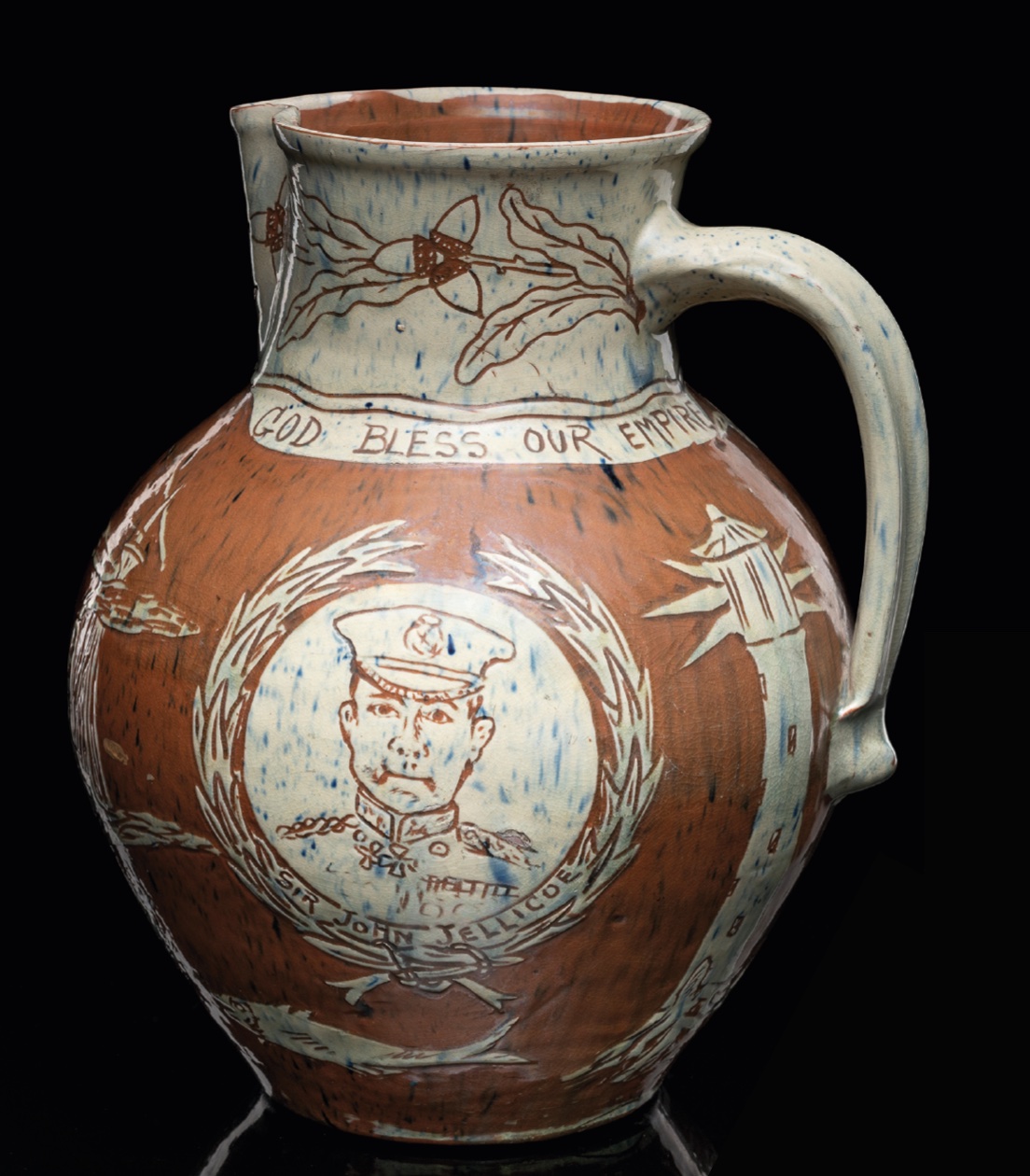 A Fishley Pottery jug that reflects the momentous events of the time with a steamboat flanked by images of Kitchener and Jellicoe below 'God Bless Our Empire' motto